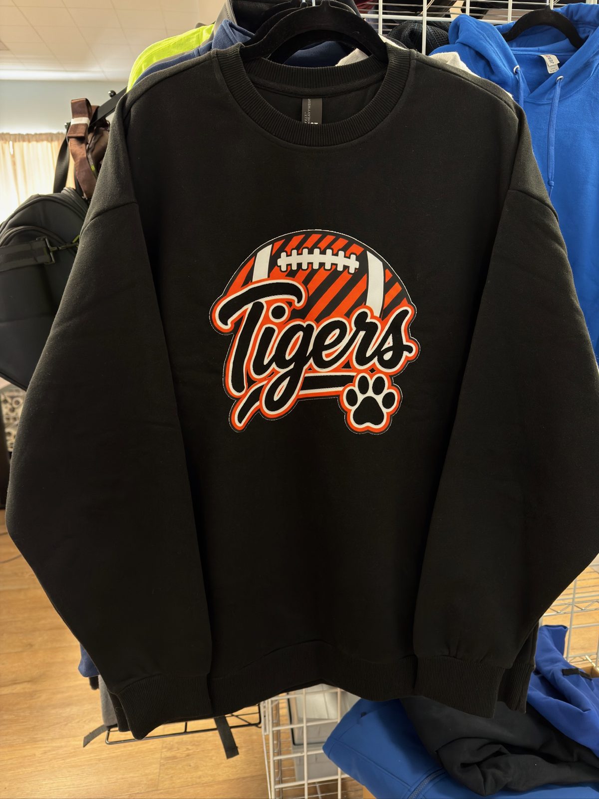 Moody flat lay of hoodies, tees, and hats with custom printing